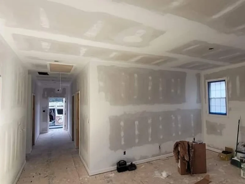 Room with unfinished drywall seams and construction materials