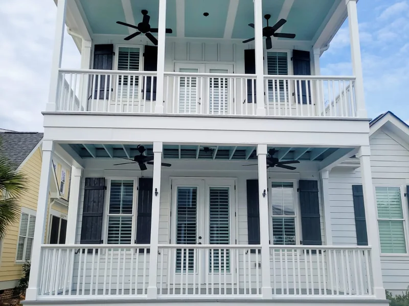 White house exterior with stacked porches and railings